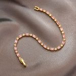 Gold and pink chain bracelet